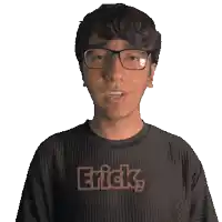 a man wearing glasses and a black shirt that says erick on it