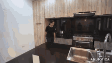 a woman standing in a kitchen with the words made in animatica on the bottom right