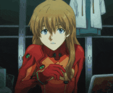 a girl in a red suit with a green emblem on her chest