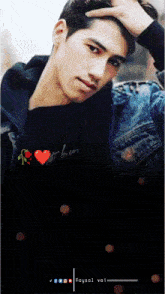 a man in a denim jacket holds his hand to his forehead
