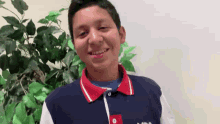 a young man wearing a blue shirt with the word tommy on it