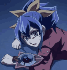 a girl with a bow in her hair is laying on the ground holding a card