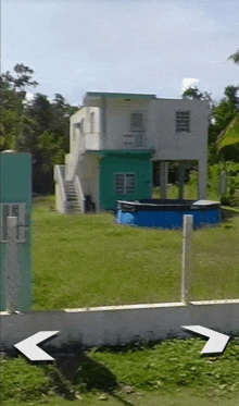 an arrow points to a house with a blue pool in the backyard