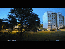 a building with a lot of windows and a tree in front of it