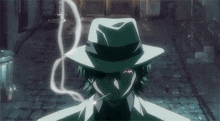 a man in a fedora is smoking a cigarette .