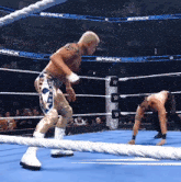 two men are wrestling in a ring with smackdown banners