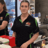 a woman wearing a black shirt with a strawberry logo on it