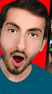 a man with a beard and a blue shirt is making a surprised face .