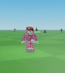a hello kitty character is standing in a field