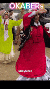 a woman in a red dress is dancing in front of a crowd and the words okabers are above her