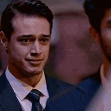 a man in a suit and tie looks sad