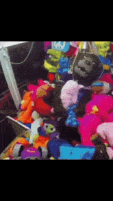 a bunch of stuffed animals including a gorilla with a peace sign on it