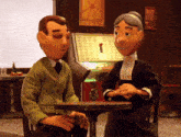 a man and a woman are sitting at a table and talking