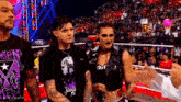 a group of people are standing in a wrestling ring with one wearing a shirt that says ' judge ' on it