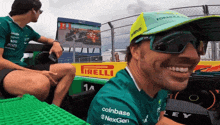 a man wearing sunglasses and a hat that says formula one on it