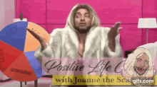 a man in a fur coat stands in front of a spinning wheel with the words positive life on it