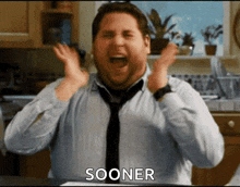 a man in a tie is screaming in a kitchen with the word sooner in the corner