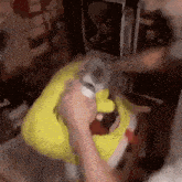 a person is holding a stuffed animal that looks like spongebob squarepants