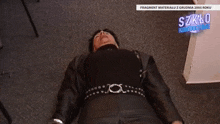 a woman is laying on the floor in front of a sign that says szklc