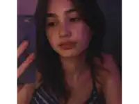 a woman taking a selfie with her phone and giving a peace sign