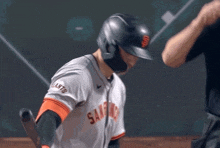 a san francisco giants baseball player holds his bat