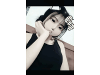 a girl in a black tank top with a bow on her head