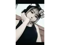 a girl in a black tank top with a bow on her head