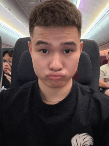 a man making a funny face while sitting in a plane