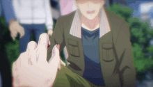 a man in a green jacket is being helped by someone