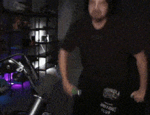a person is holding a sword in a dark room .
