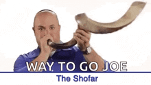 a man is blowing a shofar horn in a video .