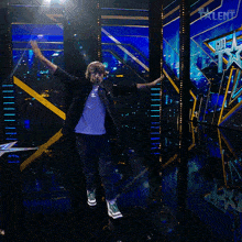 a man with his arms outstretched stands in front of a sign that says sixth talent