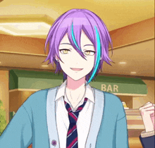 a boy with purple hair and blue streaks is wearing a tie and a cardigan .
