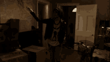 a man and a woman are dancing in a dark room in front of a lamp and a box .