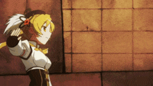 a yellow haired anime girl is standing in front of a wall holding a sword .