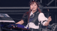 a woman in a black and white outfit playing a piano
