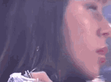 a close up of a woman 's face in a blurry photo .