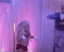 a man is throwing money at a woman who is dancing
