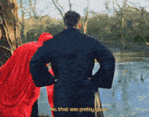 a man in a black coat is standing next to a woman in a red cape who says no that was pretty good