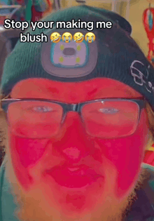 a man wearing glasses and a beanie is making a funny face with a caption that says stop your making me blush