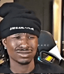a man wearing a black beanie that says illegal mafia