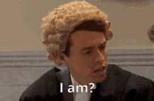 a man wearing a wig and a suit says i am