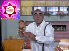 a man is standing in front of a sign that says marathi comedy family
