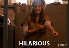 a woman in a prison uniform says hilarious on the screen