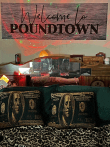 a welcome to poundtown sign hangs over a bed