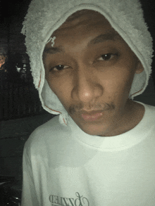 a man wearing a towel on his head and a shirt that says connected