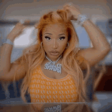 a woman wearing a necklace that says ' nicki ' on it