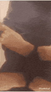 a close up of a person 's hands holding something in a blurry photo .