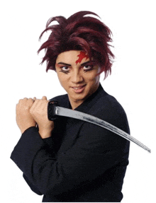 a man with red hair is holding a sword in front of his face