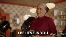 a woman says " i believe in you " in a red shirt